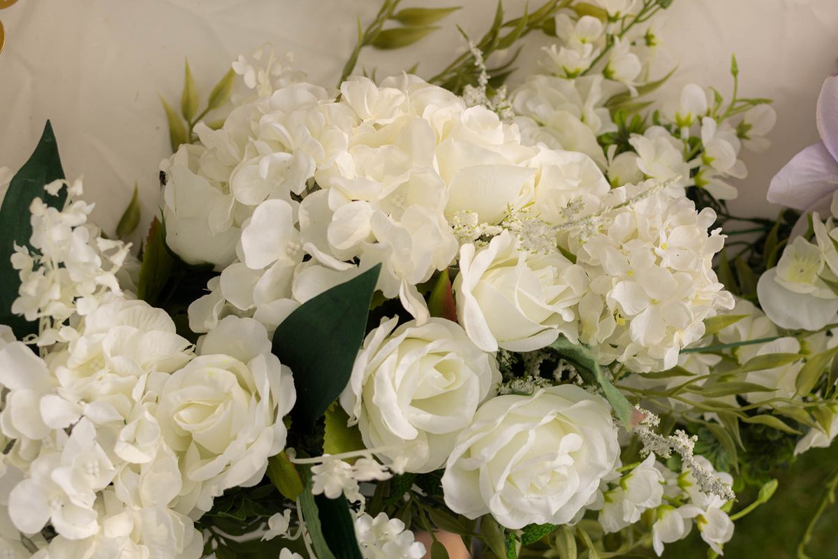 Close-up of white rose and hydrangea floral arrangements